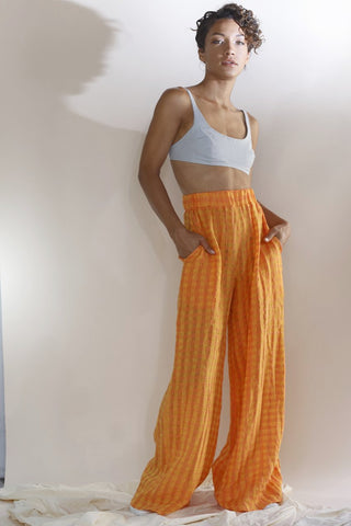 Neon orange wide-leg linen lounge pants featuring a high-rise pull-on style and elastic waistband | Love Faustine