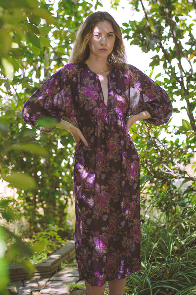 Floral dress with deep V-neckline, a kimono poet sleeve with elastic at the wrists midi length, and a sheered empire waist | Love Faustine